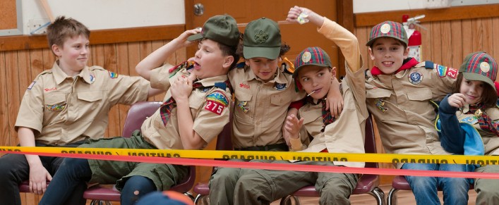 Pack 275 Scouts sitting together at an indoor event